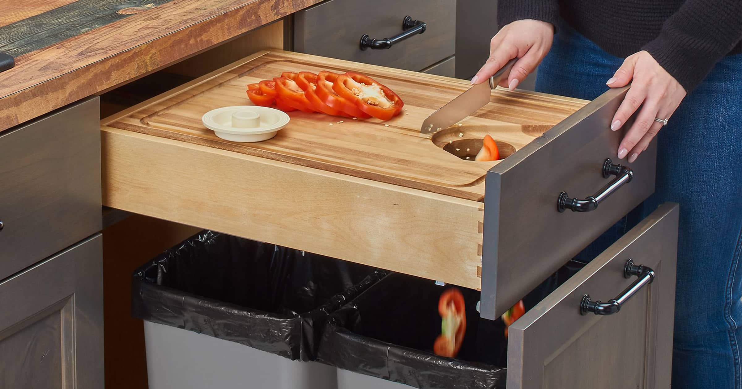 woman using cutting board which is built into drawer