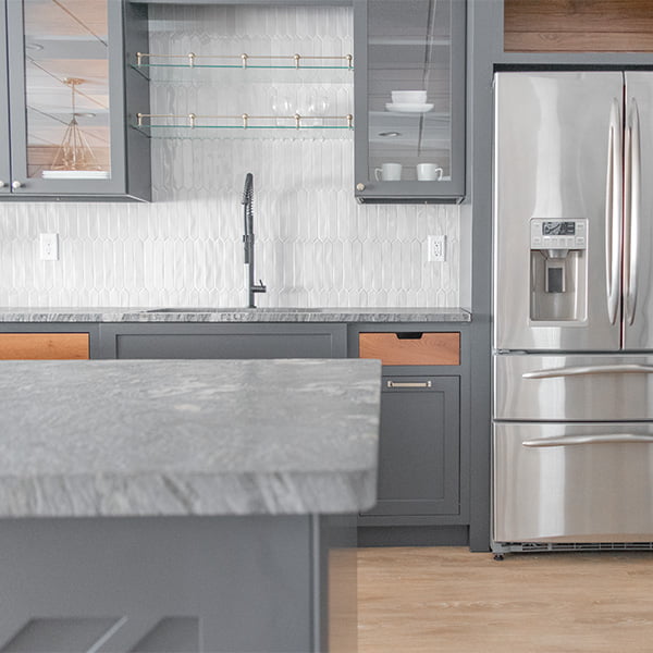 kitchen with stainless steel refrigerator and dark gray cabinets