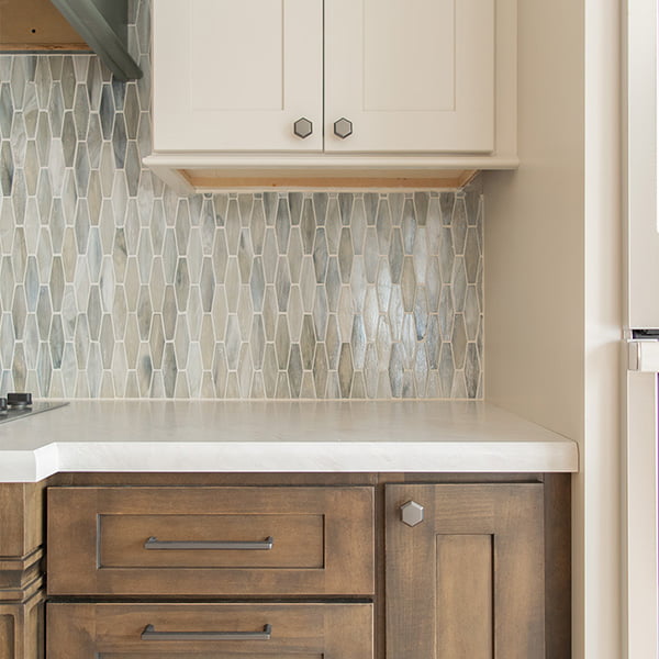 beige upper cabinet and decorative backsplash tiles