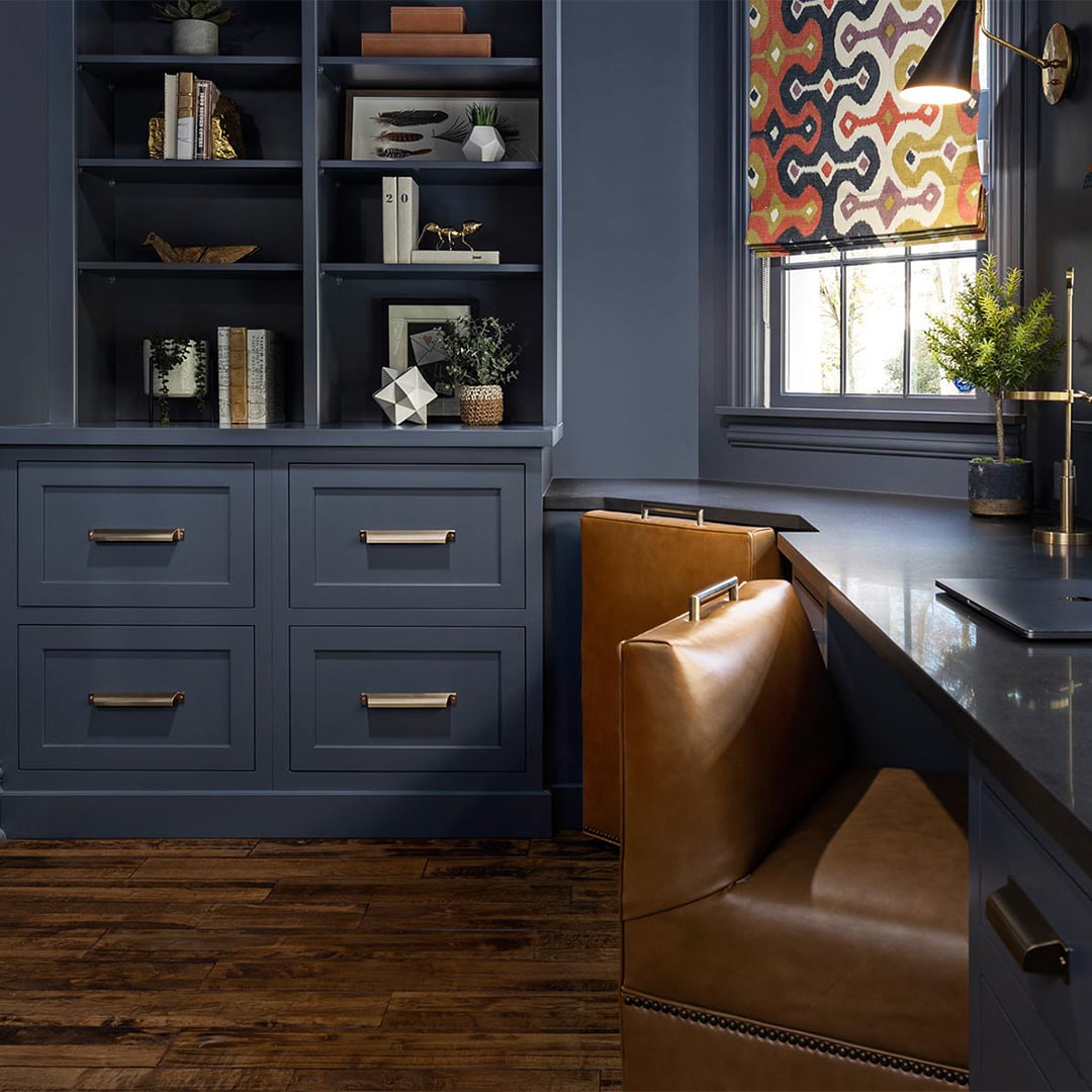 modern home office with leather chairs and blue cabinets