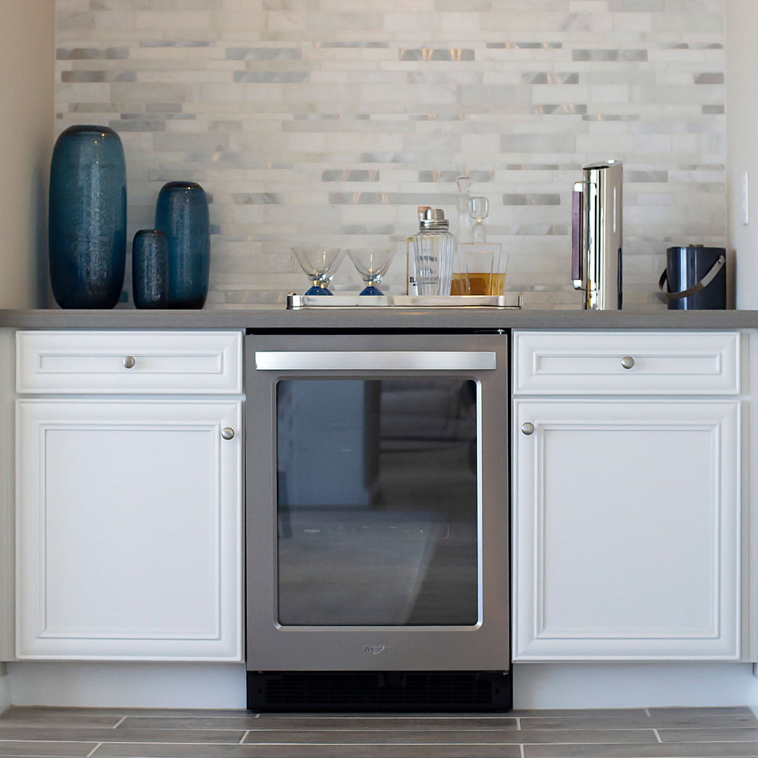 white base cabinets on wet bar in modern home