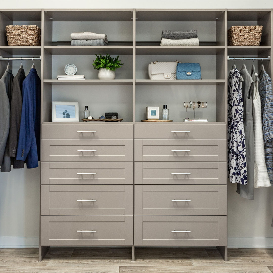 tan closet system with clothes hanging racks, shelving and drawers