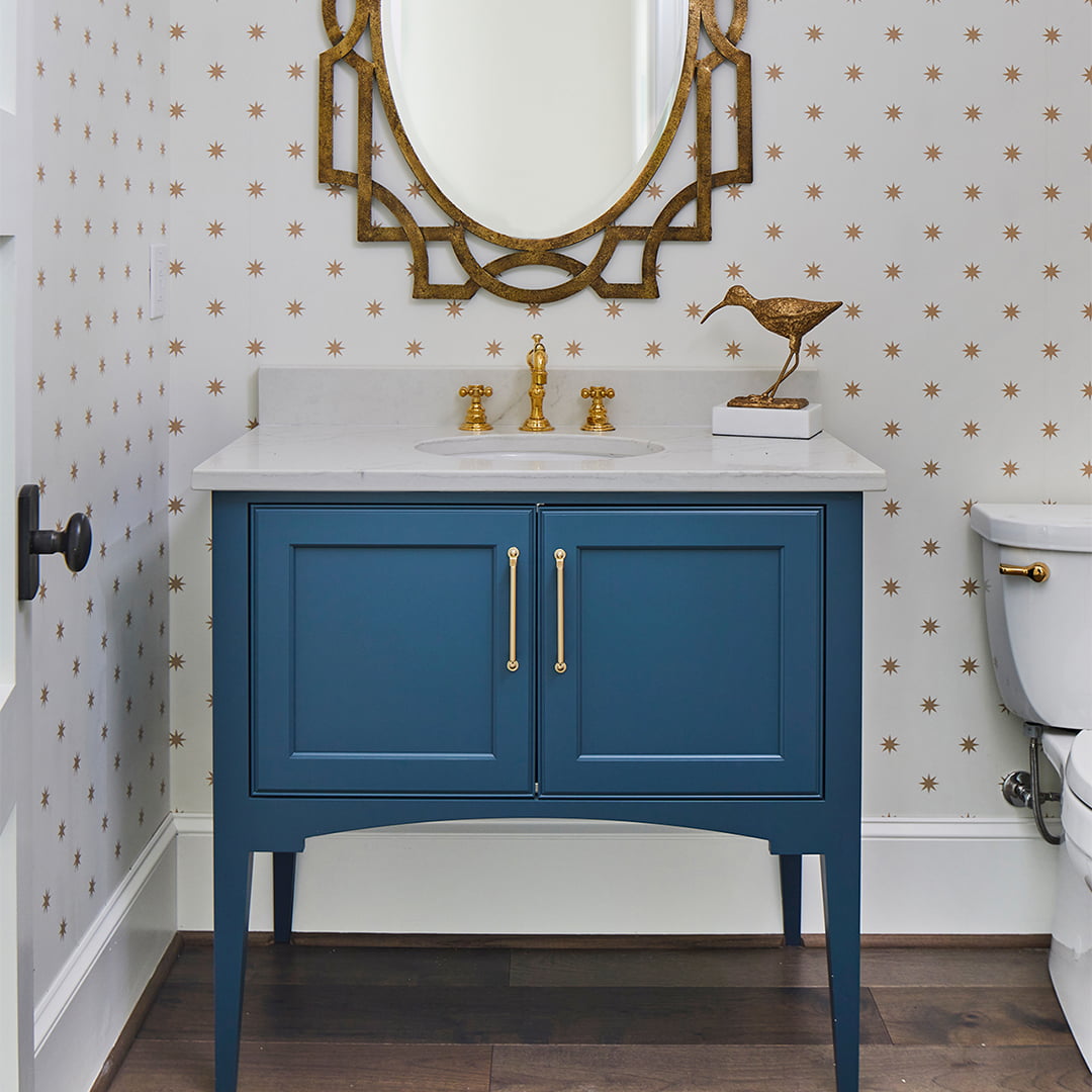 blue vanity cabinet and sink in chic bathroom