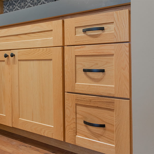 three drawer cabinet with light wood stain