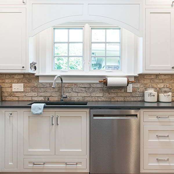 white kitchen window above stainless steel sink