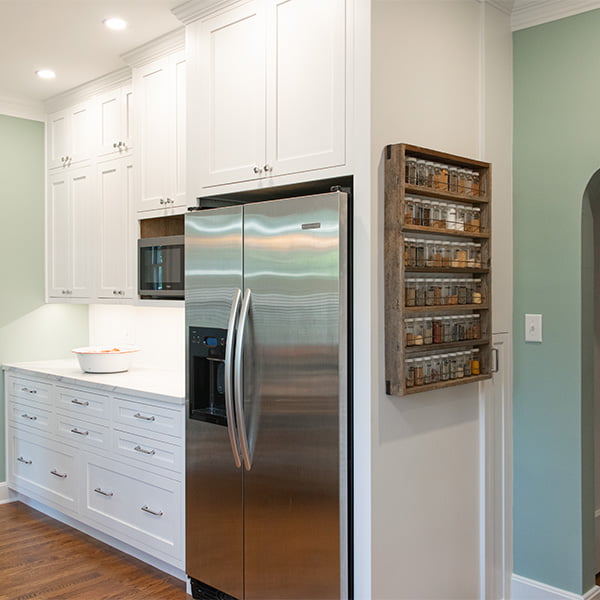 white kitchen cabinets and stainless steel refrigerator