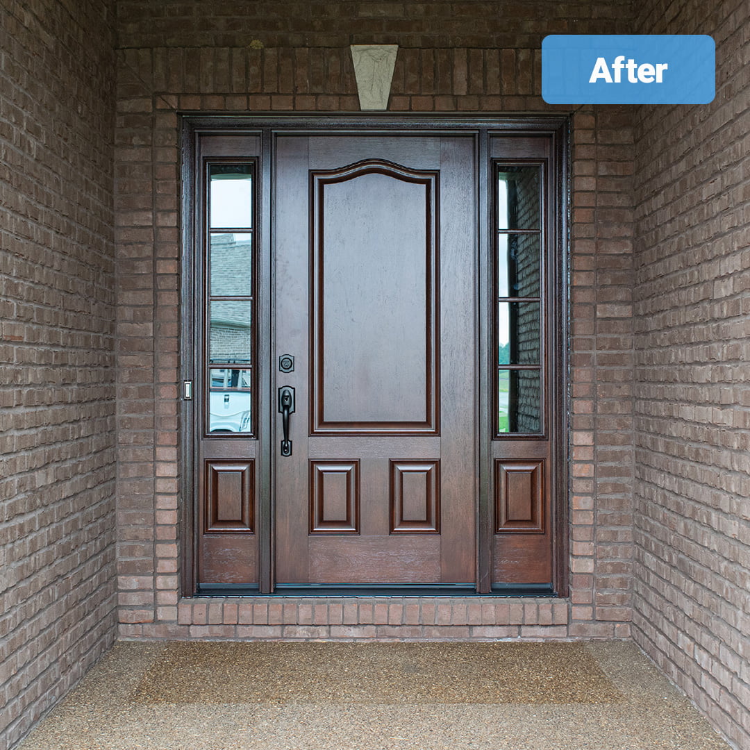 woodgrain fiberglass entry door on brick home