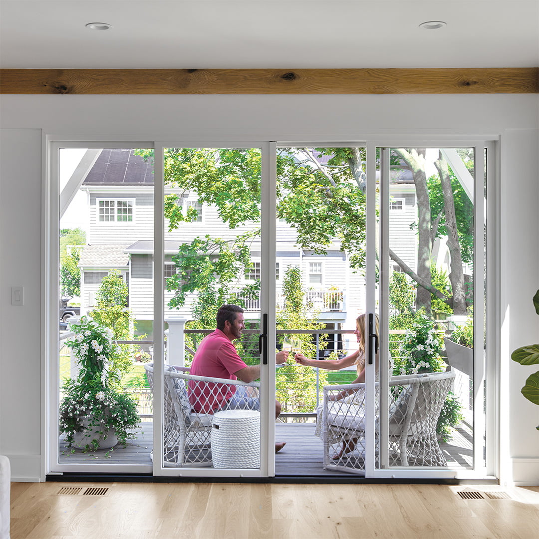 white sliding patio door leading to backyard deck