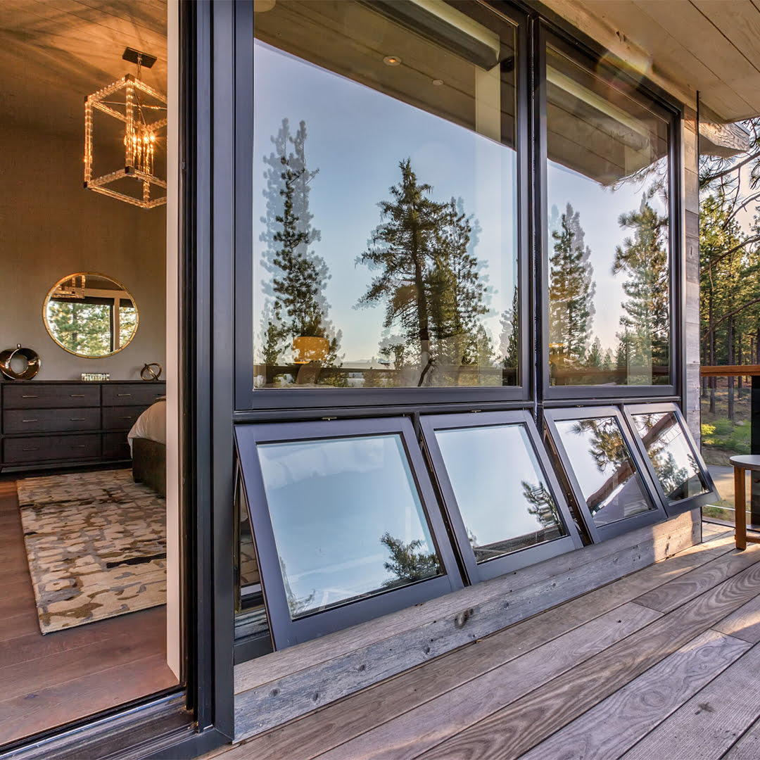 black awning windows on back porch of rustic home