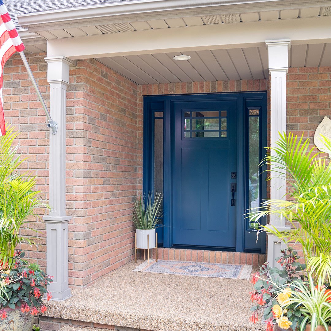 blue craftsman-style front door on brick house