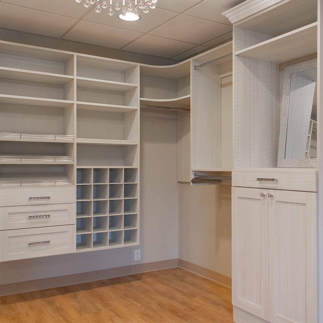 white built-in storage shelving for walk-in closet