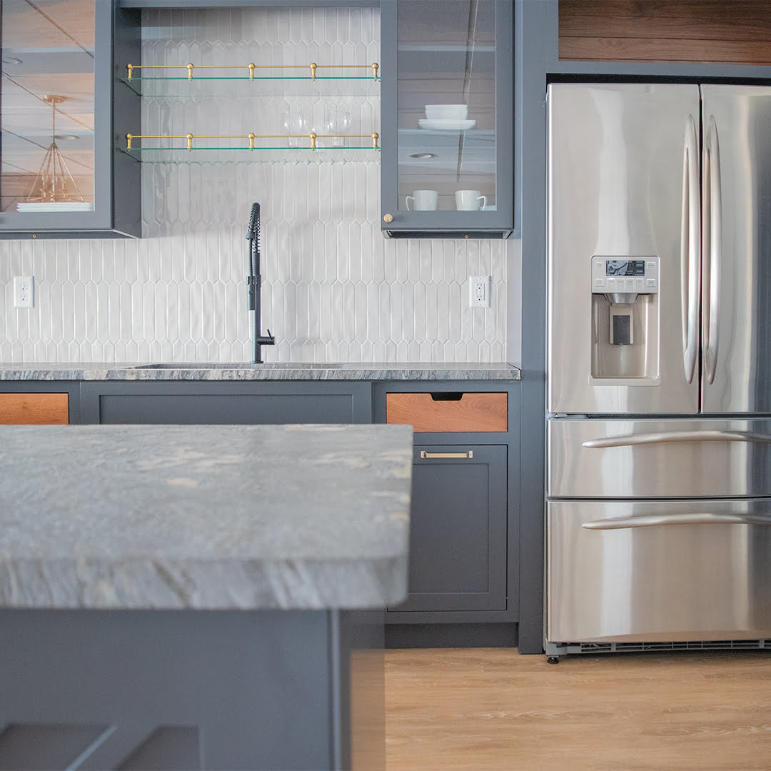 kitchen with stainless steel refrigerator and dark gray cabinets