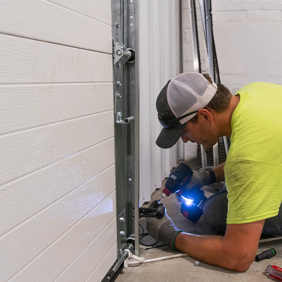 garage door technician installing floor sensors