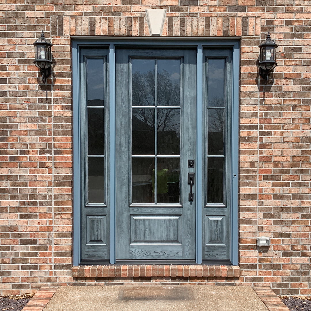 blue entry door on brick home