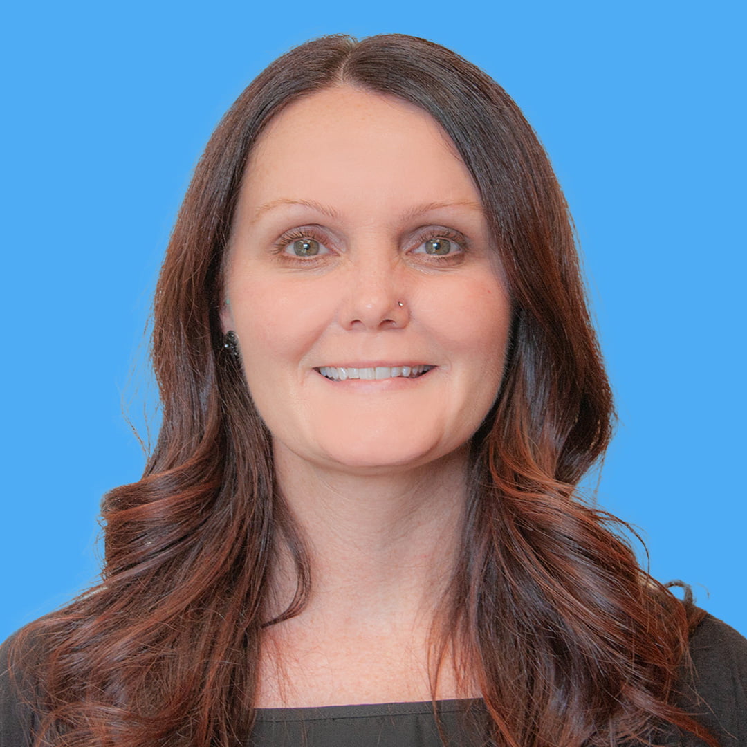 young woman with long brown hair wearing black women's dress shirt