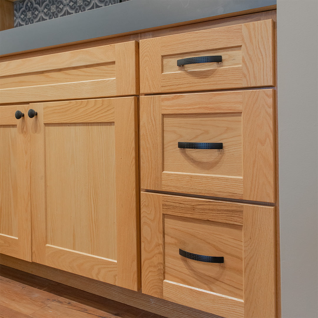 three drawer cabinet next to double door cabinet