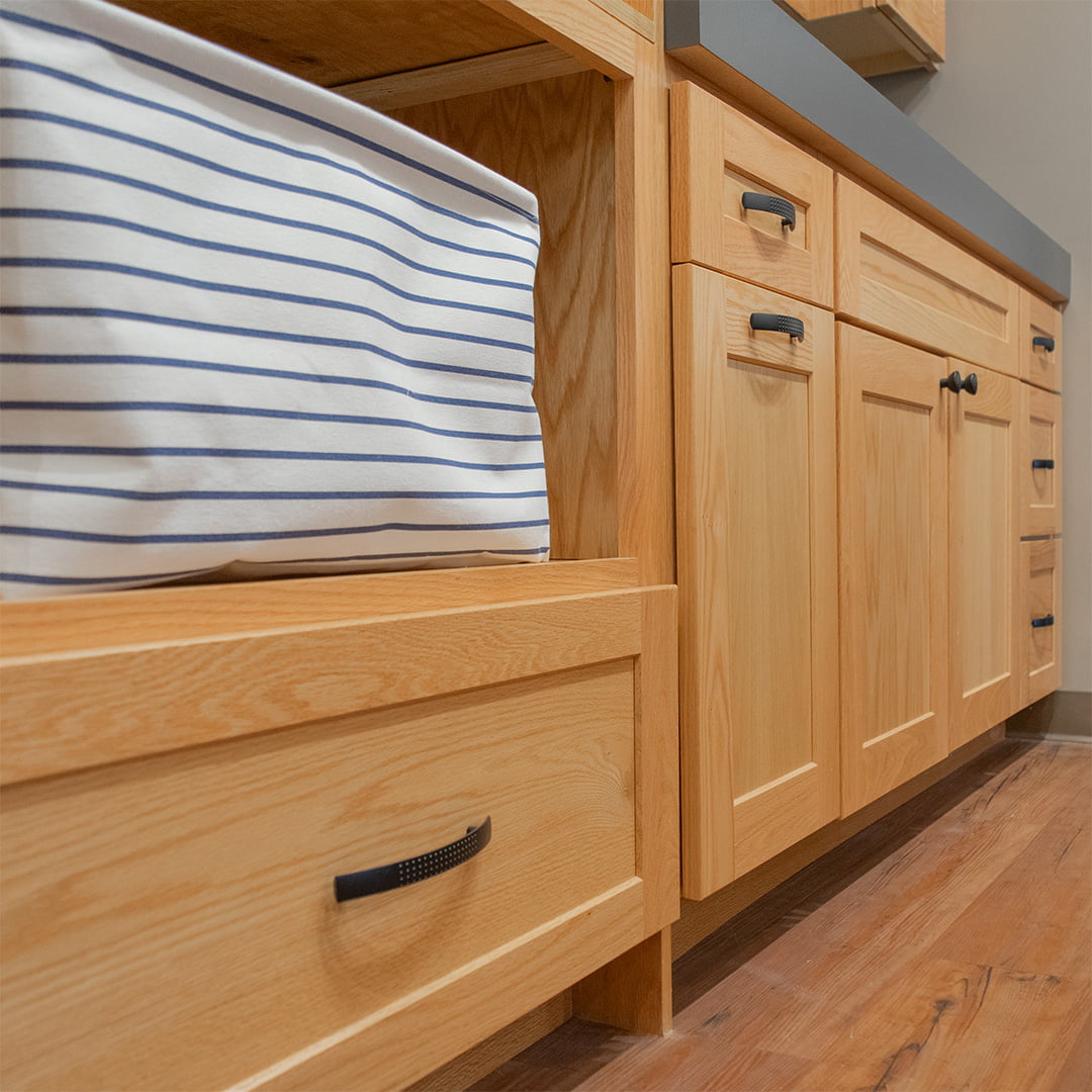 oak cabinets with natural stain and black handles