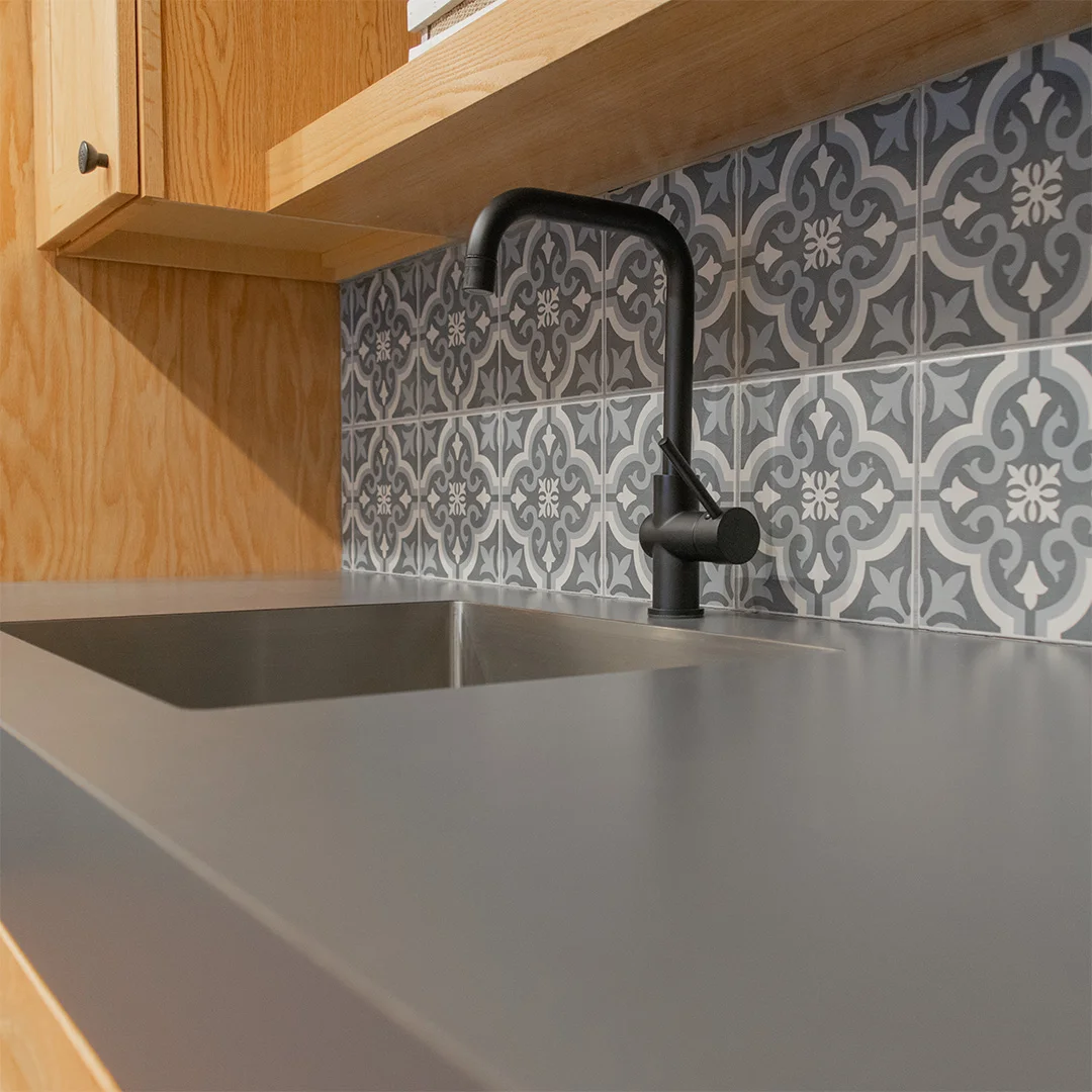 dark blue laminate countertop with natural stained cabinets