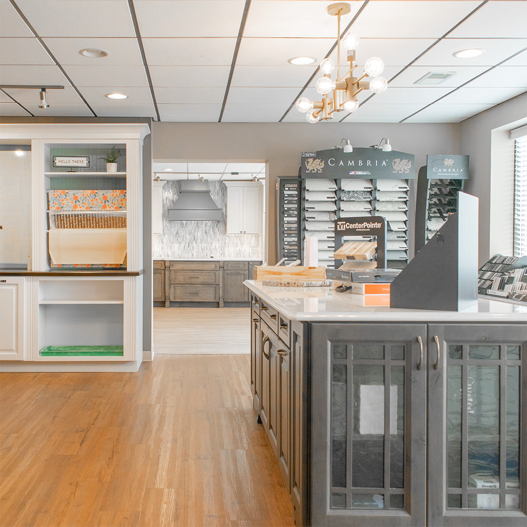 cabinet showroom with large kitchen island and countertop samples