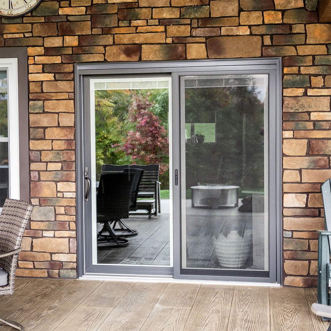 gray sliding patio doors on stone home