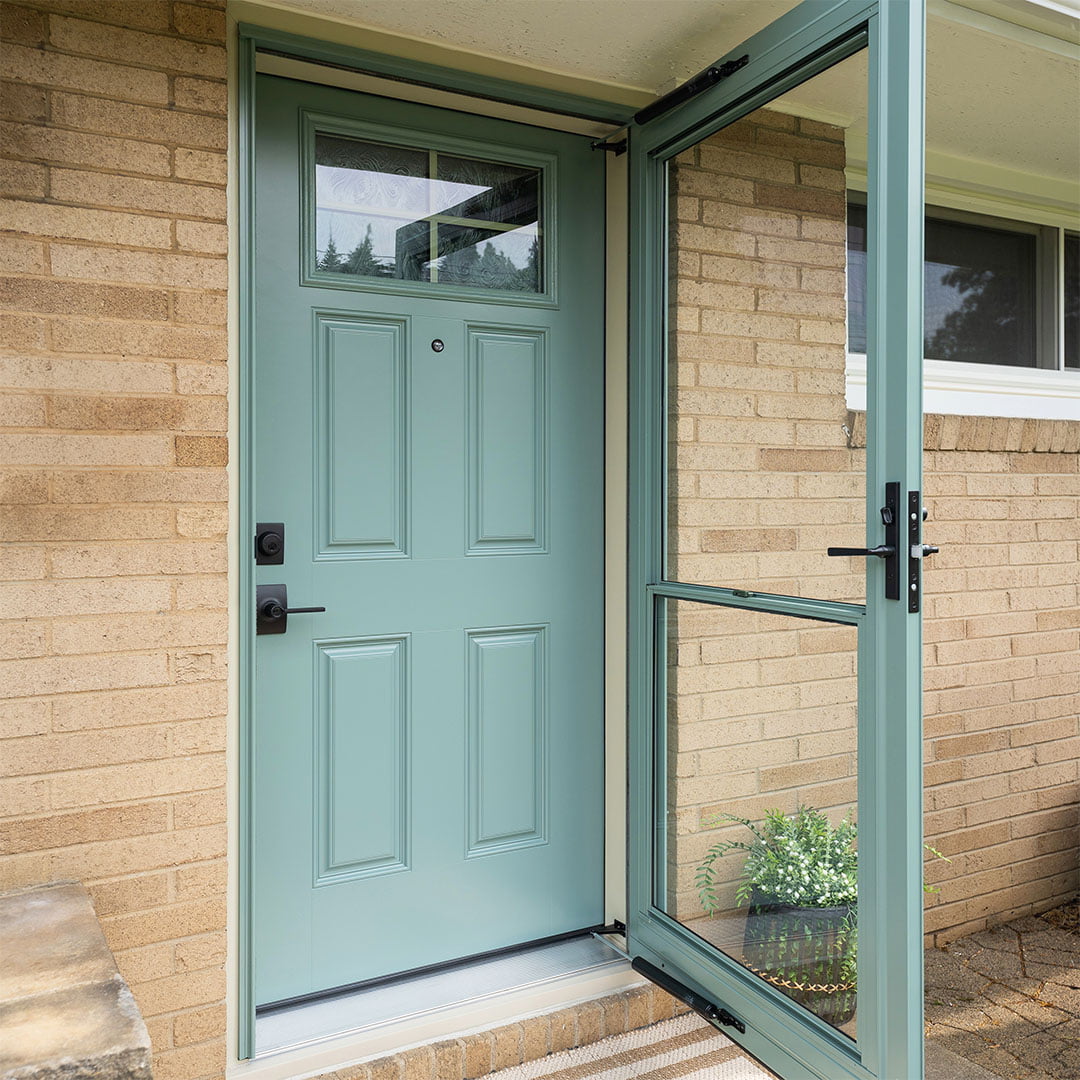 green fiberglass front door with matching storm door