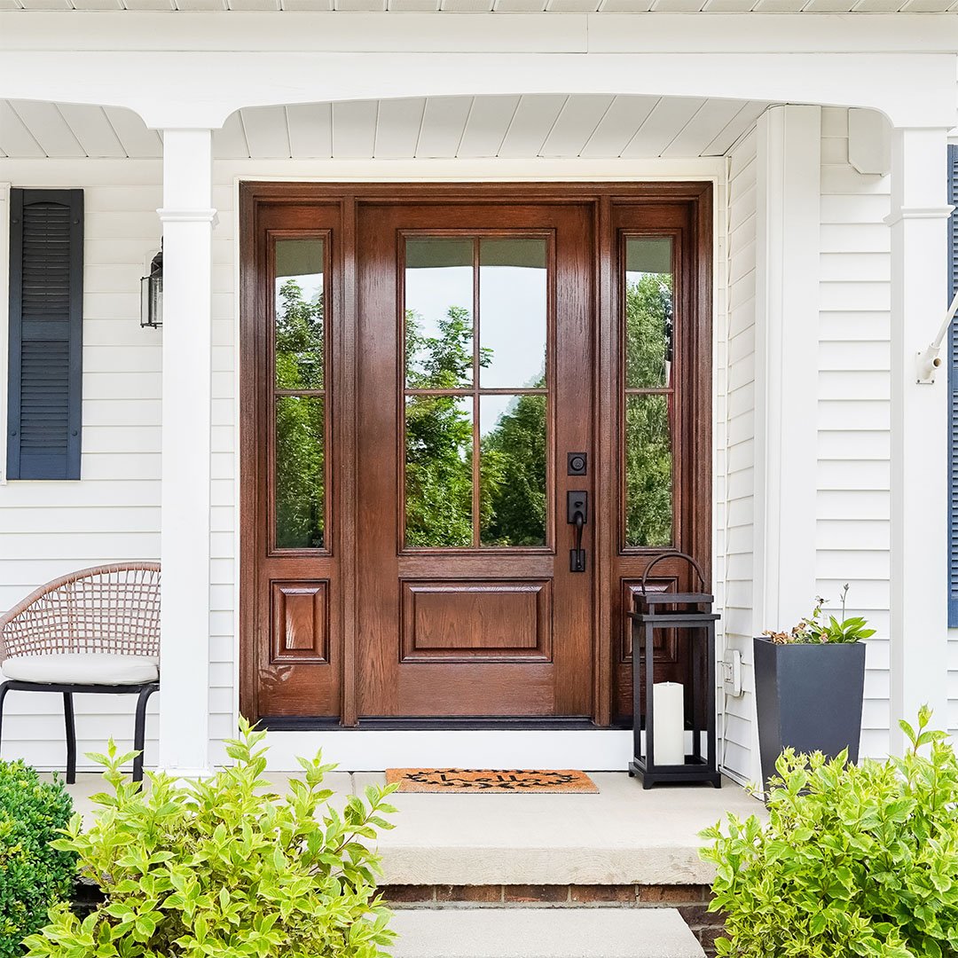 oak fiberglass door with two side lights on white house