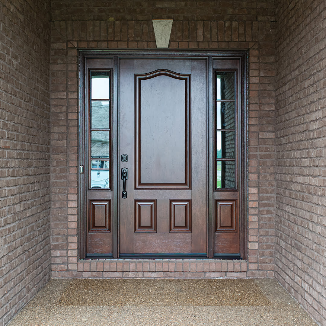 cherry woodgrain fiberglass entry door on brick home