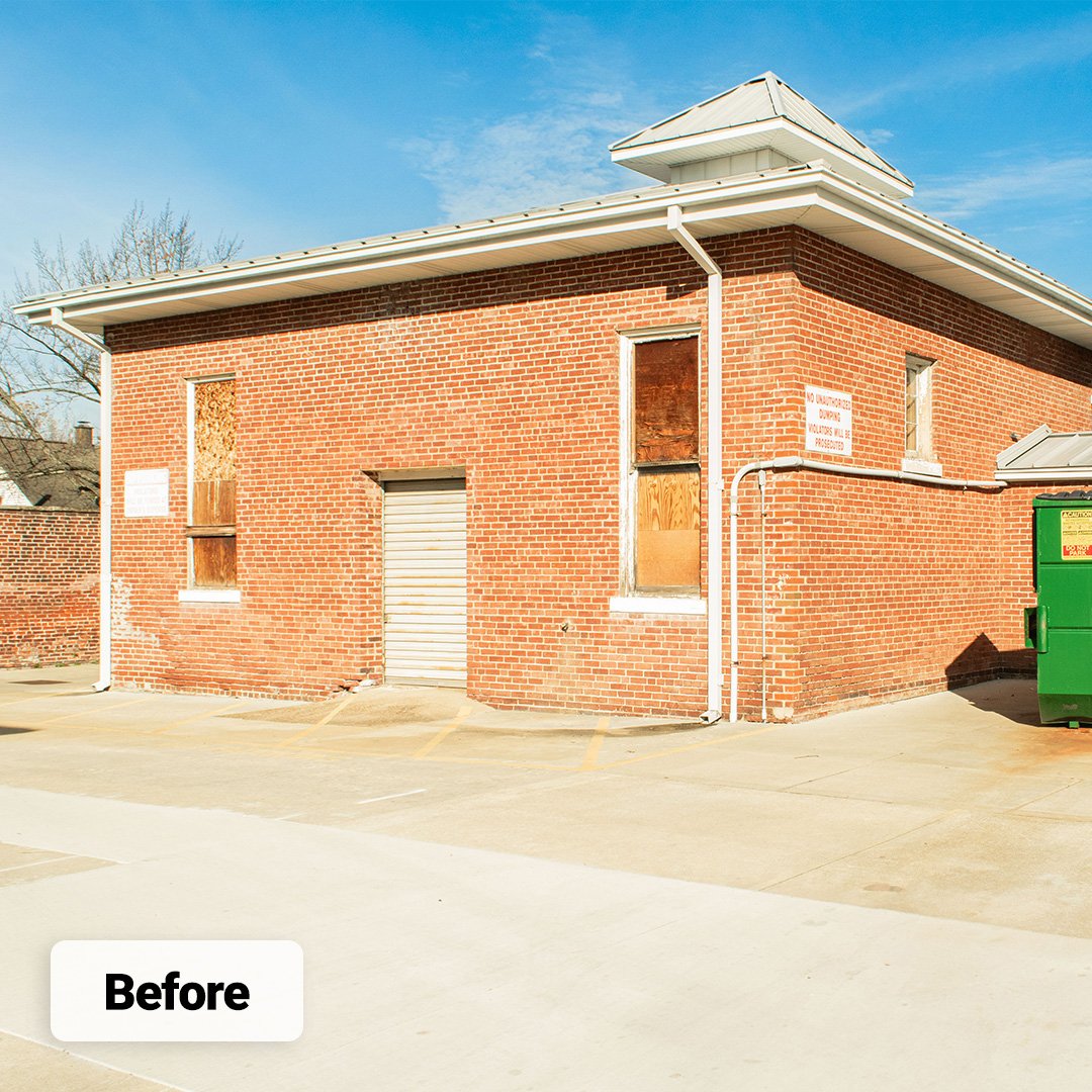 historic brick building with boarded-up windows