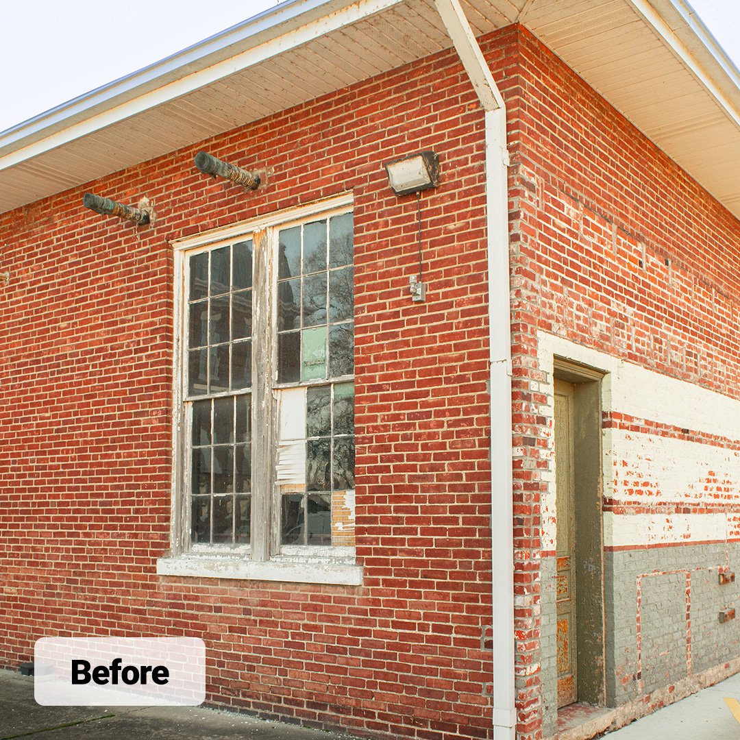 old wood picture window with grids in historic brick building