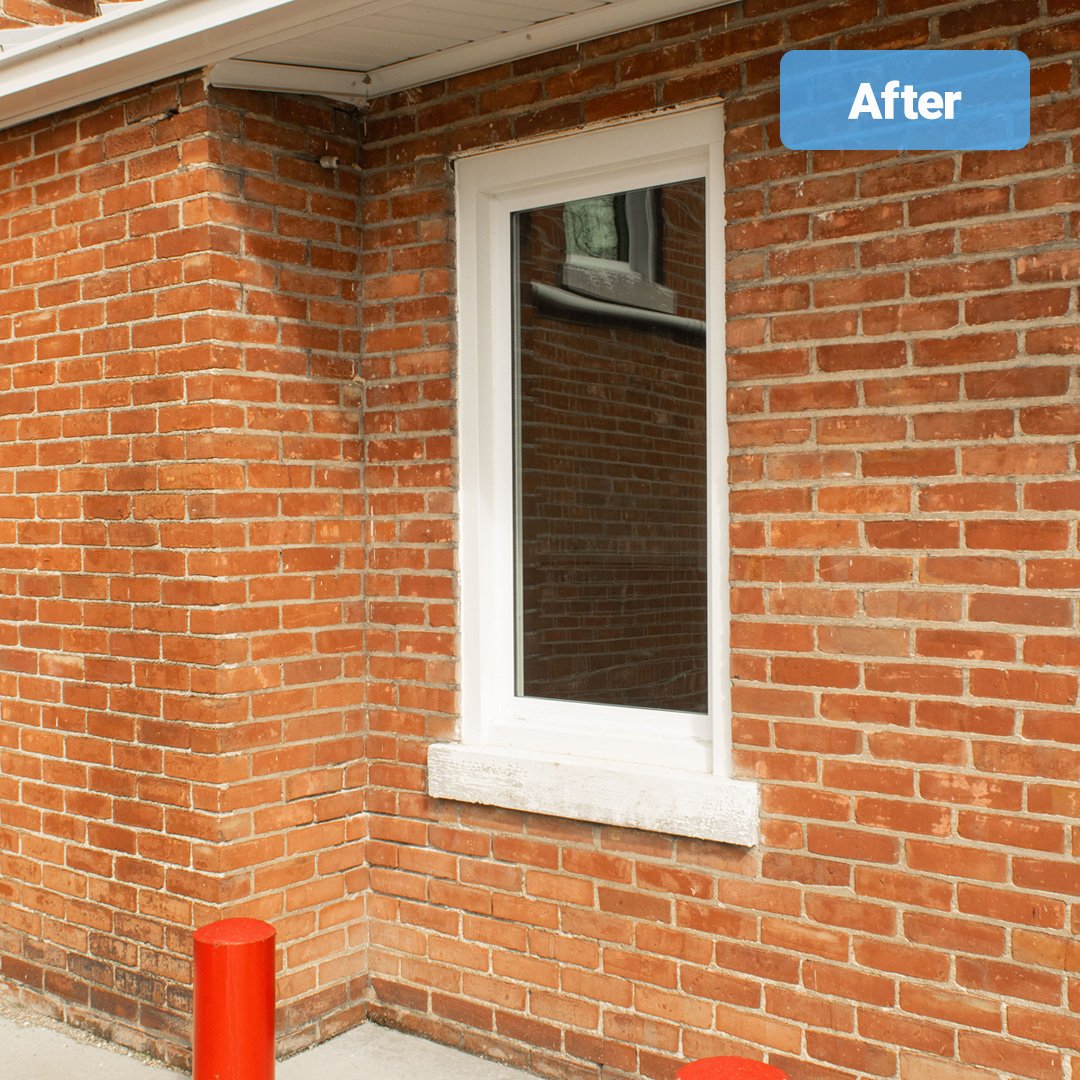 white vinyl picture window on brick wall