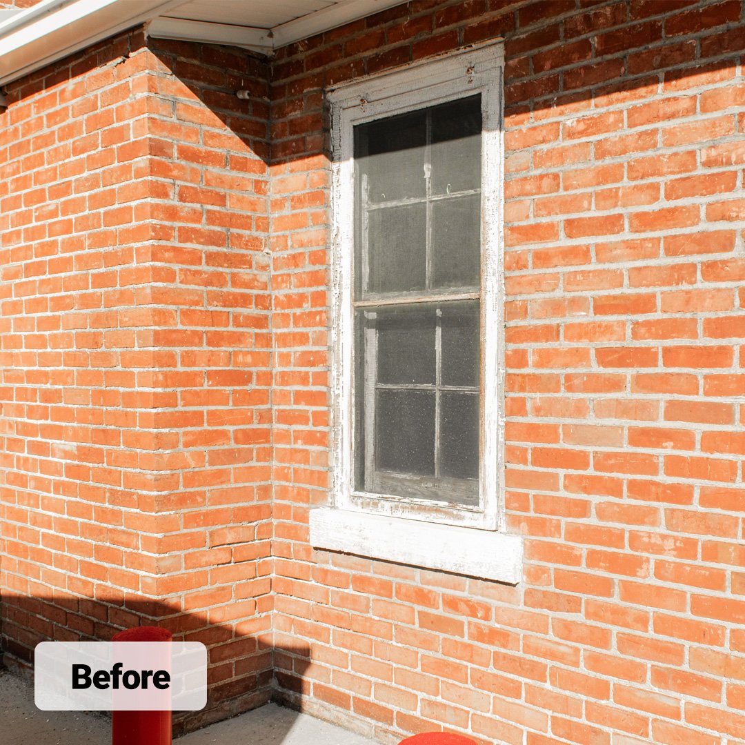 old wood single hung window on brick wall