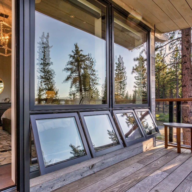 black framed picture and awning windows on rustic home