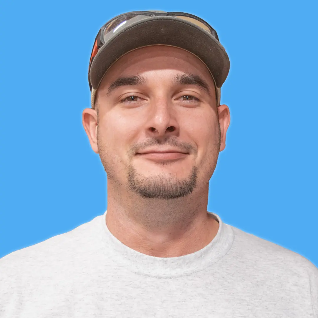 young adult male wearing gray shirt, gray hat and black sunglasses