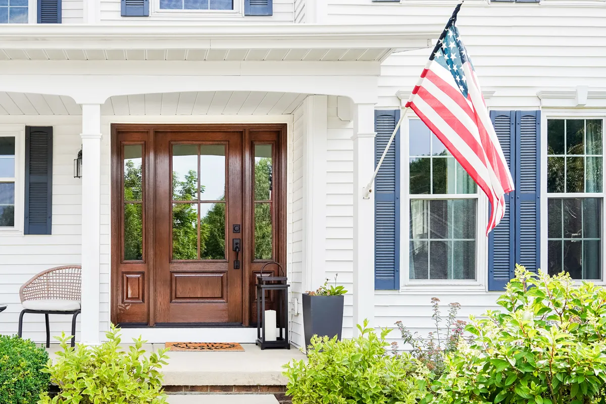 fiberglass replacement front door on white colonial-style home