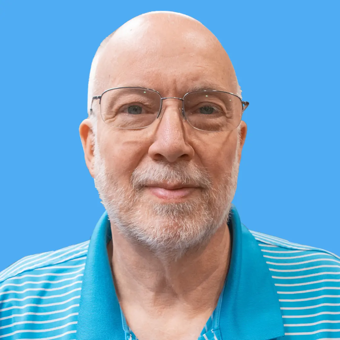 photo of adult male wearing glasses and striped blue dress shirt